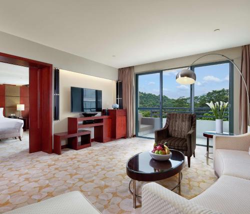 a living room with a couch and a table at Hilton Guangzhou Science City, Free Shuttle Bus to Canton Fair in Guangzhou