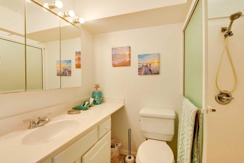 a bathroom with a sink and a toilet and a mirror at Sunny Florida Condo 4 Mi to Gulf Islands Seashore in Fort Walton Beach
