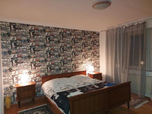 a bedroom with a wall covered in photographs at Mona Apartments in Skopje