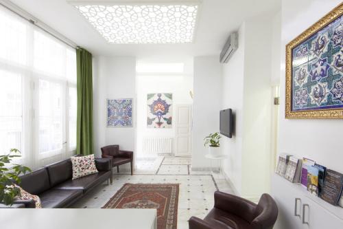 a living room with a couch and a window at Pi Art Butik Otel in Istanbul