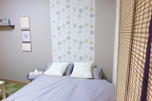 a bed with two pillows on it in a room at Daiichi Mitsumi Corporation - Vacation STAY 14915 in Musashino
