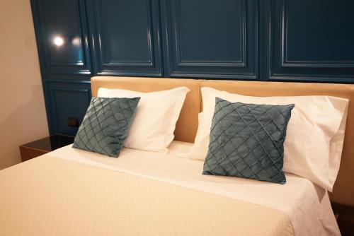 a bed with two pillows on top of it at Re Di Cuori Hotel in Caianello