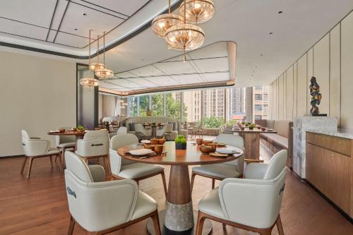 a dining room with a table and chairs at Hilton Changsha Riverside in Changsha