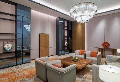 a living room with a couch and a table at Hilton Changsha Riverside in Changsha
