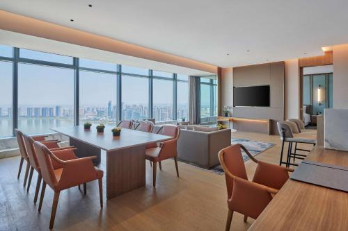 a conference room with a table and chairs and a television at Hilton Changsha Riverside in Changsha