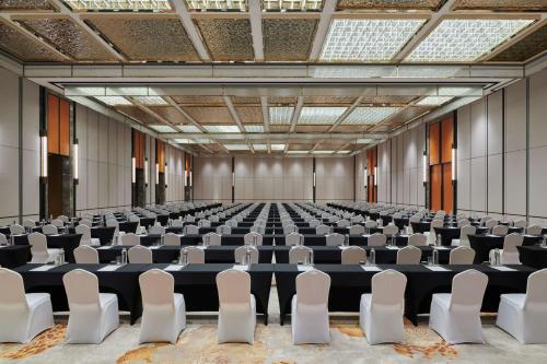 an empty room with rows of chairs in it at Hilton Changsha Riverside in Changsha
