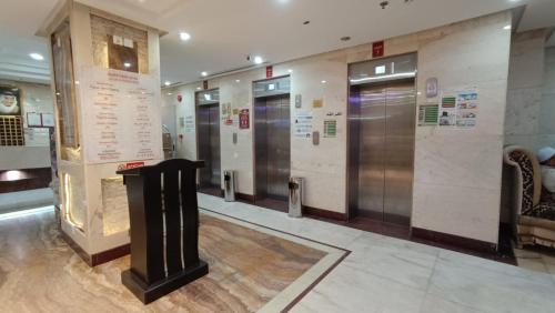 a lobby with several elevators in a building at Luluat Al sharq Al Awsat in Makkah