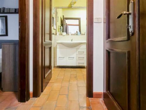 a bathroom with a white sink and a mirror at La Casina di Rosi vivere nellantico borgo in Castiglione della Pescaia