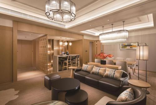 a living room with a couch and a table at Doubletree By Hilton Chengdu Longquanyi in Chengdu