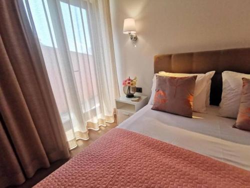 a bedroom with a large bed with a large window at Chalé Esmeralda - Charming Studios in Calheta Beach in Calheta