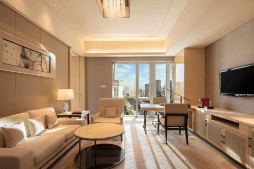 a living room with a couch and a table at Hilton Dalian in Dalian