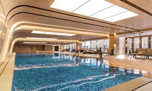 a large swimming pool in a hotel lobby at Conrad Hangzhou in Hangzhou