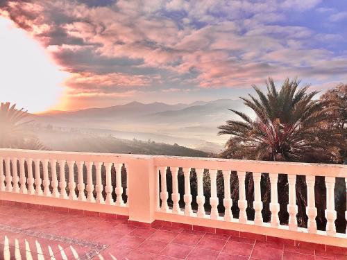 a white fence with a view of mountains at Dar Bakkali Nadi in Tangier