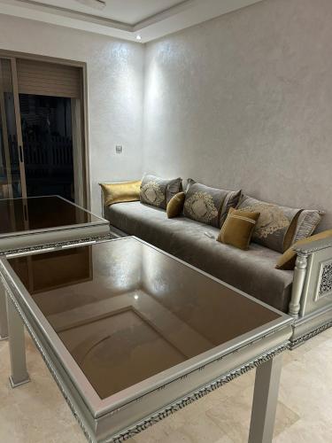 a living room with a couch and a table at Marina saidia luxury Duplex pool & garden view in Saidia 