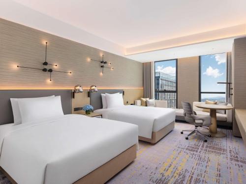 Ένα ή περισσότερα κρεβάτια σε δωμάτιο στο Doubletree By Hilton Kunming Airport