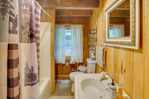 a bathroom with a tub and a toilet and a sink at Historic Cabin Retreat about 2 Mi to Seneca Rocks! in Seneca Rocks