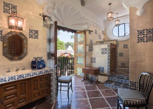 a bathroom with a sink and a shower with chairs at Hacienda Acamilpa in Acamilpa