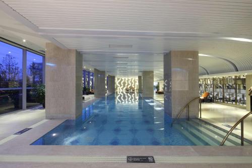 a lobby with a swimming pool in a building at Hilton Nanjing Riverside in Nanjing