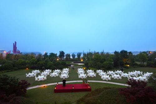 an aerial view of a wedding ceremony in a park at Hilton Nanjing Riverside in Nanjing