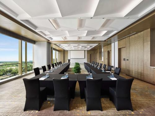 a large conference room with a long table and chairs at DoubleTree by Hilton Qidong in Qidong