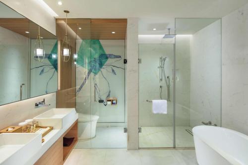 a bathroom with a shower and a toilet and a sink at Hilton Garden Inn Shanghai Hongqiao NECC in Shanghai