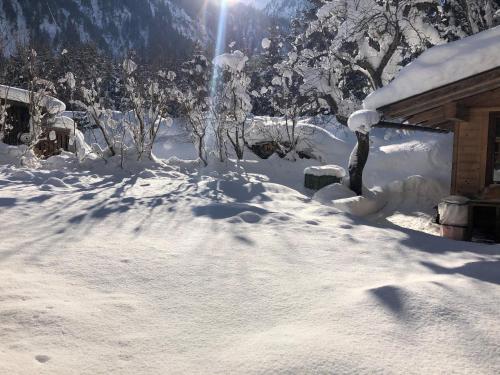 a yard covered in snow next to a house at Appartement Ginzling Haus Eder in Ginzling