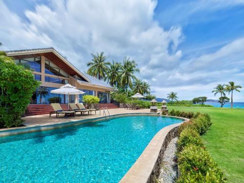 an exterior view of a house with a swimming pool at Hilton Sanya Yalong Bay Resort & Spa in Sanya