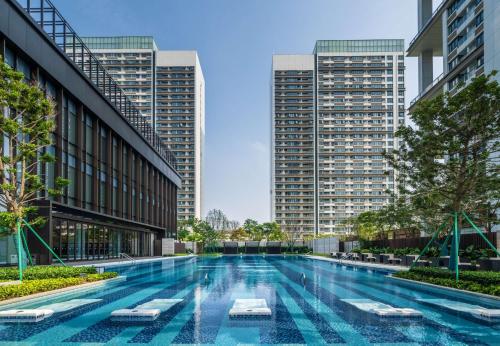 a swimming pool in a city with tall buildings at Hilton Shenzhen World Exhibition & Convention Center in Shenzhen