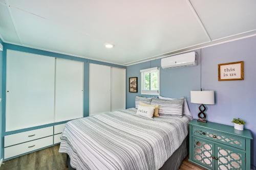 a bedroom with a bed and a blue wall at Low-Key Poway Home about 20 Mi to La Jolla and San Diego in Poway