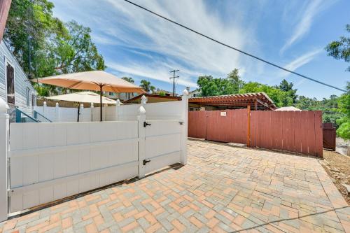a white fence with an umbrella and a brick driveway at Low-Key Poway Home about 20 Mi to La Jolla and San Diego in Poway