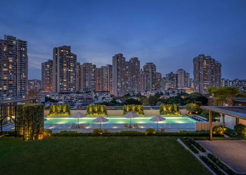 a swimming pool with a city skyline in the background at Waldorf Astoria Xiamen in Xiamen