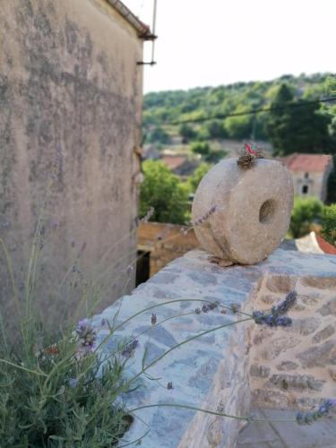 a stone vase sitting on top of a stone wall at Villa Teza Hvar in Hvar