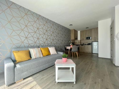 a living room with a couch and a table at B144 Design Lux Apartments #FreeParking in Budapest