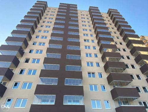 a tall building with many windows on it at Luxury apartments - Otoka Sarajevo in Sarajevo