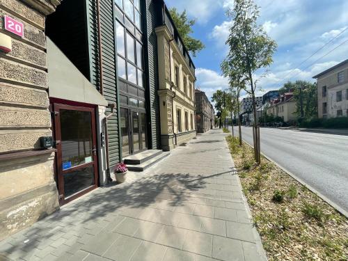 an empty sidewalk next to a building on a street at Modern guest house in city center I Room 2 in Vilnius