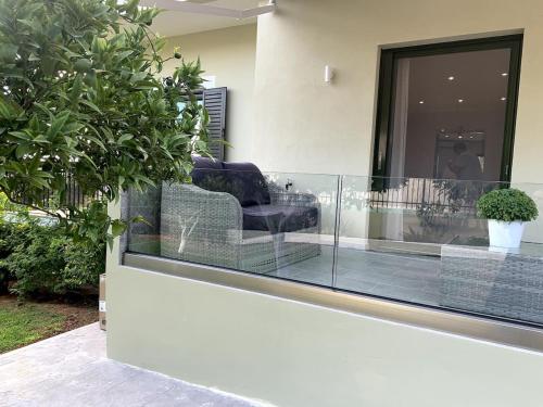 a lobby with two chairs sitting on a balcony at Luxury Home with Garden in the Suburbs in Kalamata