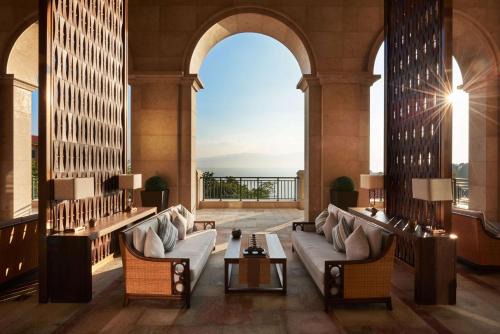 a lobby with couches and a view of the ocean at Hilton Yuxi Fuxian Lake in Chengjiang