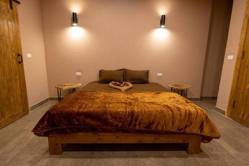 a bedroom with a large bed with two tables at The Sand apartment in Dahab