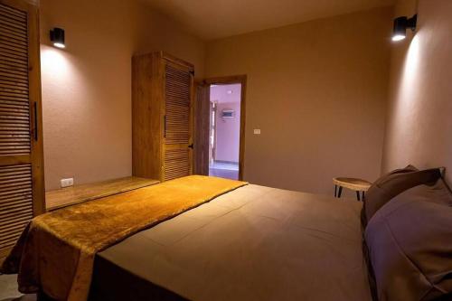 a bedroom with a large bed in a room at The Sand apartment in Dahab
