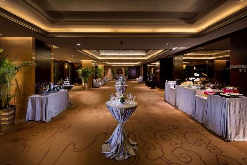 a banquet hall with tables with white tablecloths at Hilton Xiamen, Lobby Links to Metro&shopping mall, Near train station in Xiamen