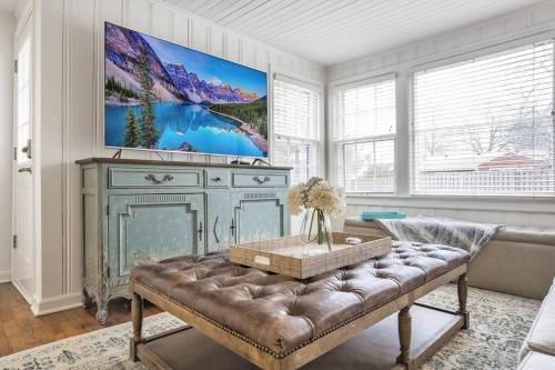 a living room with a couch and a large painting on the wall at Quaint, dog-friendly Prairie Village Home! in Prairie Village