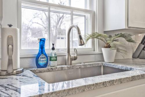 a kitchen counter with a sink and a window at Quaint, dog-friendly Prairie Village Home! in Prairie Village