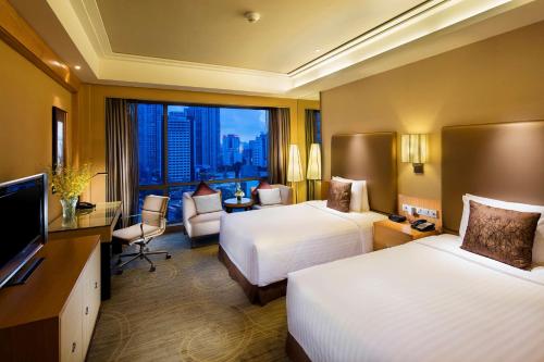 a hotel room with two beds and a large window at Hilton Xiamen, Lobby Links to Metro&shopping mall, Near train station in Xiamen
