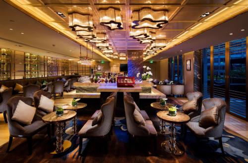 a bar with chairs and a table in a room at Hilton Xiamen, Lobby Links to Metro&shopping mall, Near train station in Xiamen