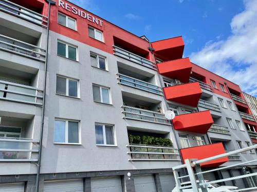 a building with red balconies on the side of it at Resident Apartment in Košice