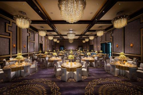 a banquet hall with tables and chandeliers at Waldorf Astoria Chengdu in Chengdu