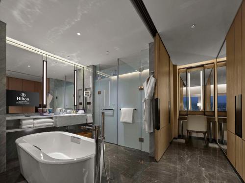 a bathroom with a bath tub and a sink at Hilton Foshan Shunde - Free Canton Fair Shuttle Bus in Shunde