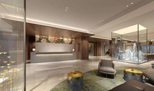 a lobby of a hotel with a chair and a table at DoubleTree by Hilton Taipei Zhongshan in Taipei