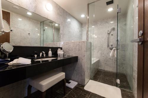 a bathroom with a sink and a shower at ANA Crowne Plaza Yonago, an IHG Hotel in Yonago
