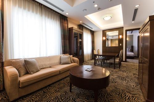 a living room with a couch and a table at ANA Crowne Plaza Yonago by IHG in Yonago